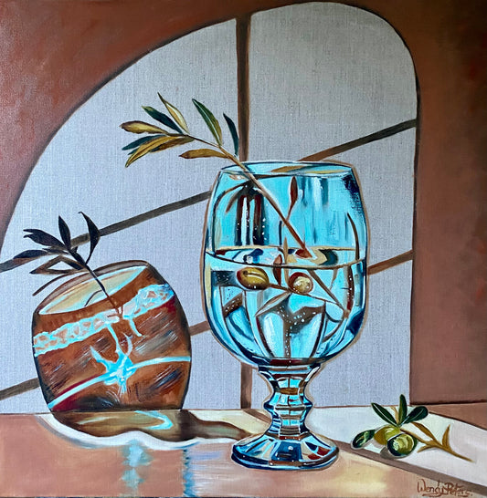 Blue glass and olive branch by Wendy Peters.  A painting of a vivid blue glass with an olive branch in it, with quirky shadows from the glass on the wall behind